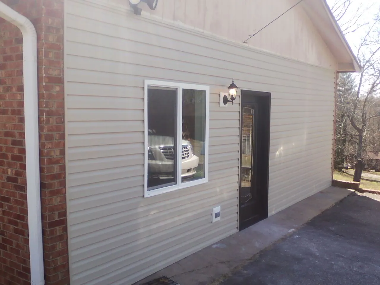 New vinyl siding and entry door on a room addition in Wickliffe